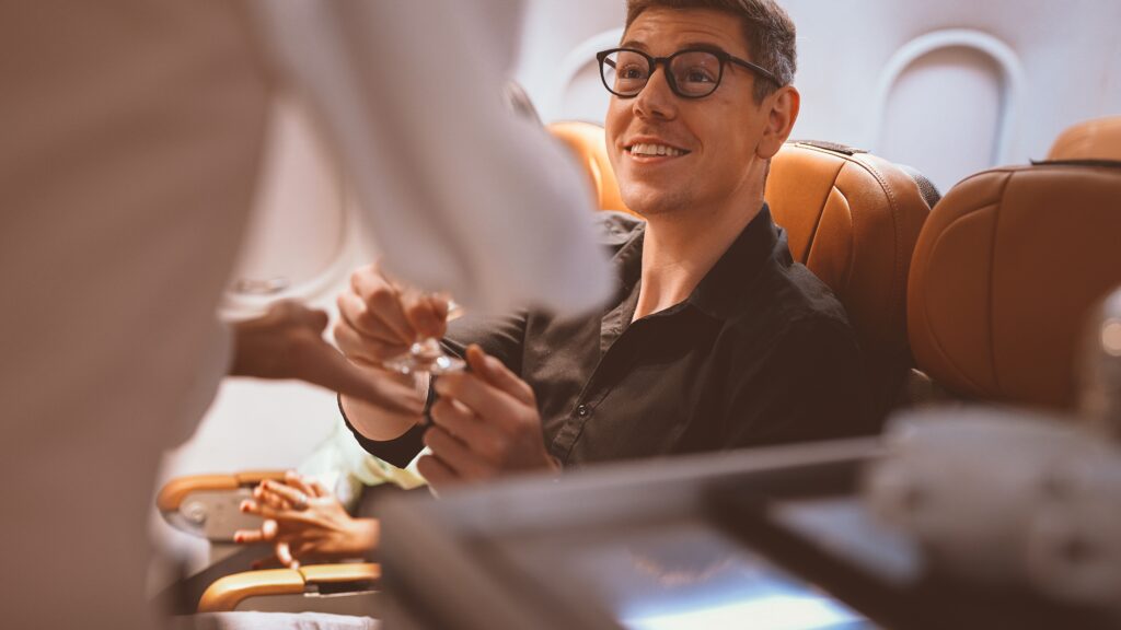 Passenger on a flight being served by airline crew